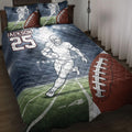 Football quilt blanket on a bed with a running player, field graphics, footballs, and bold sports artwork