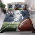 Football quilt bedding styled in a bedroom with a running player, field artwork, and large football graphics