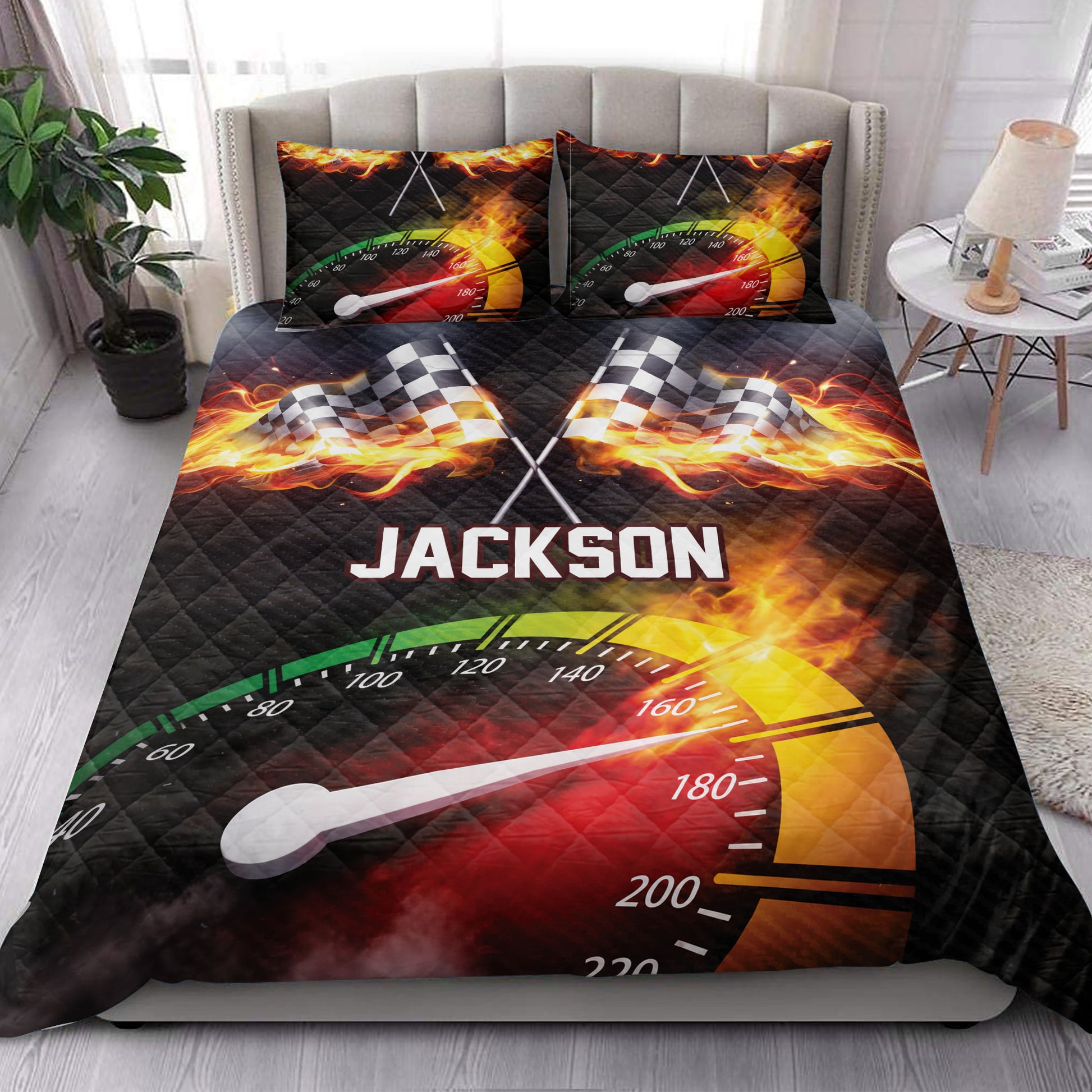 Racing quilt blanket styled on a bedroom bed with fiery checkered flag artwork