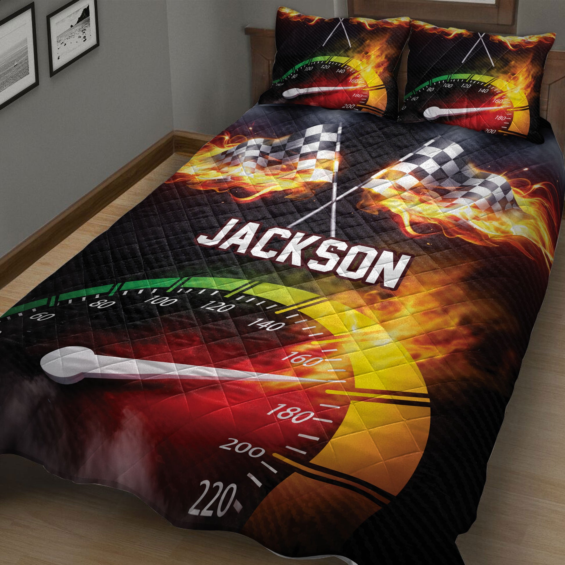 Close-up racing quilt blanket with checkered flags, flames, speedometer graphics, and black background