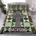Irish quilt blanket styled in a bright bedroom with a large Celtic cross, green shamrocks, and knotwork design