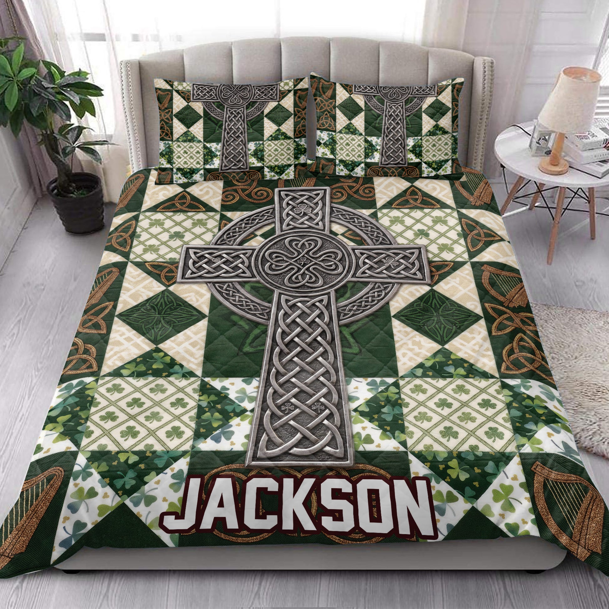 Irish quilt blanket styled in a bright bedroom with a large Celtic cross, green shamrocks, and knotwork design