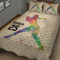 Angled bedroom view of a colorful softball quilt blanket with batter artwork
