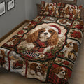 Close bedroom view of a Cavalier King Charles quilt blanket with festive plaid, poinsettias and snowy cabin artwork