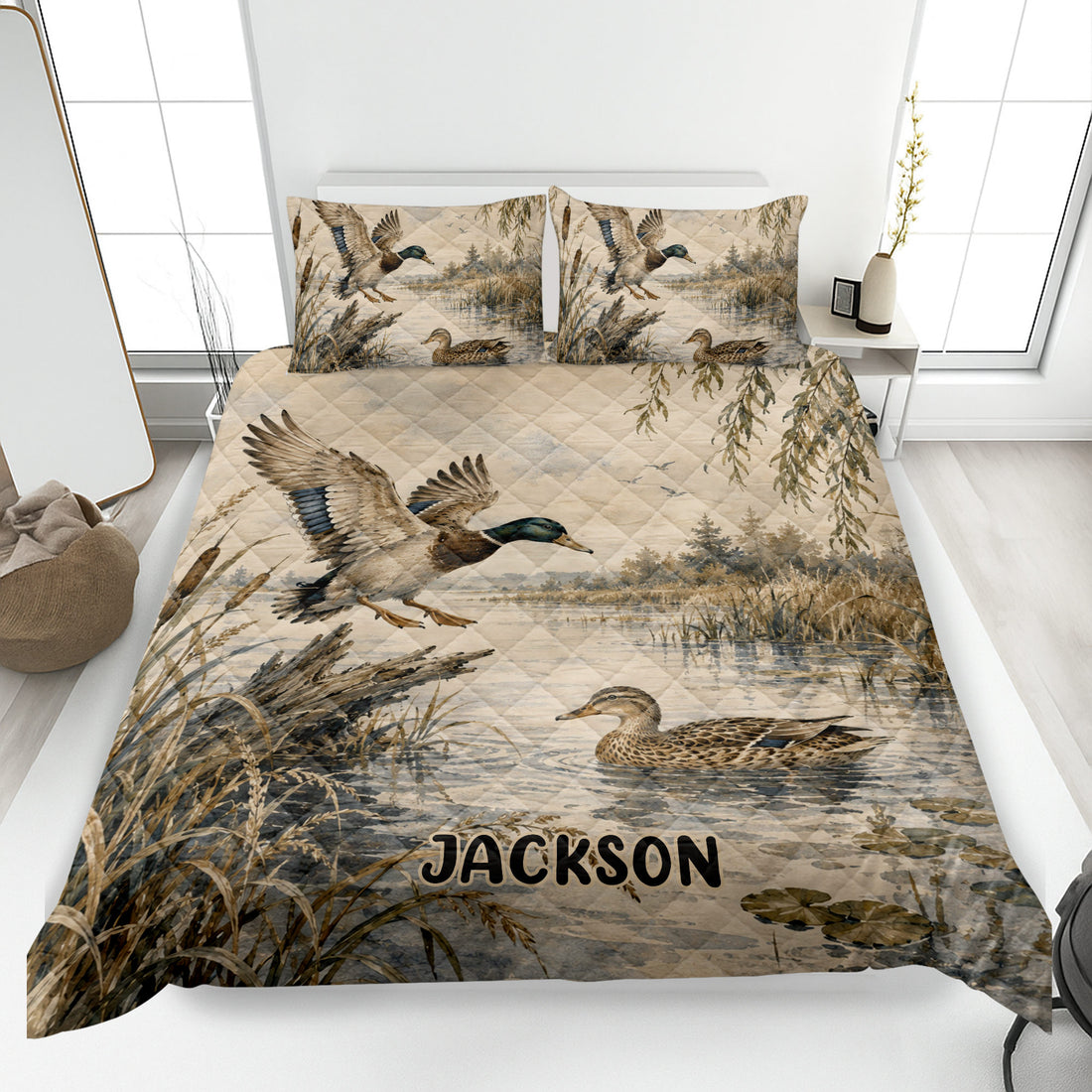 Duck hunting quilt blanket displayed on a bed with mallards, marsh reeds, water, and custom artwork