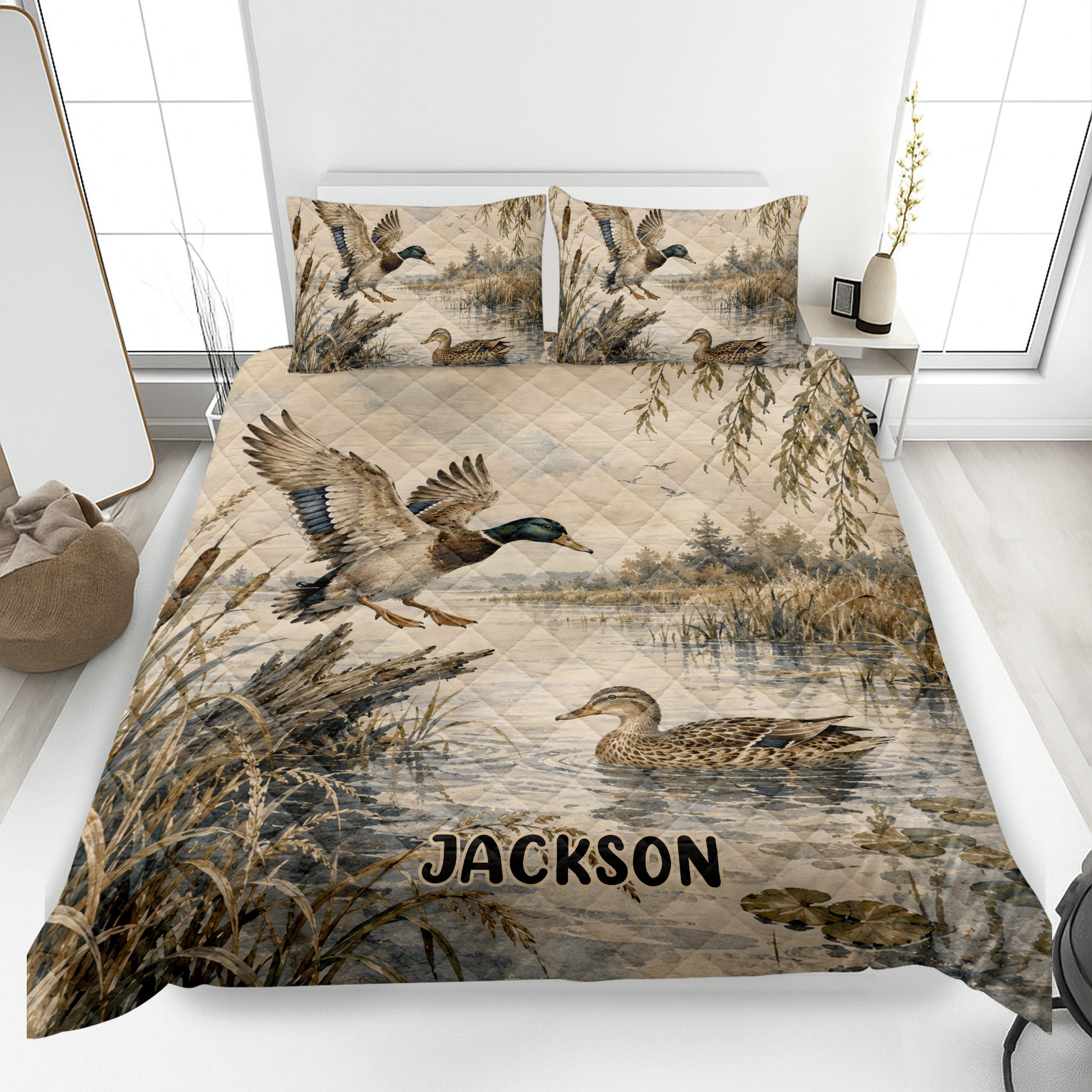 Duck hunting quilt blanket displayed on a bed with mallards, marsh reeds, water, and custom artwork