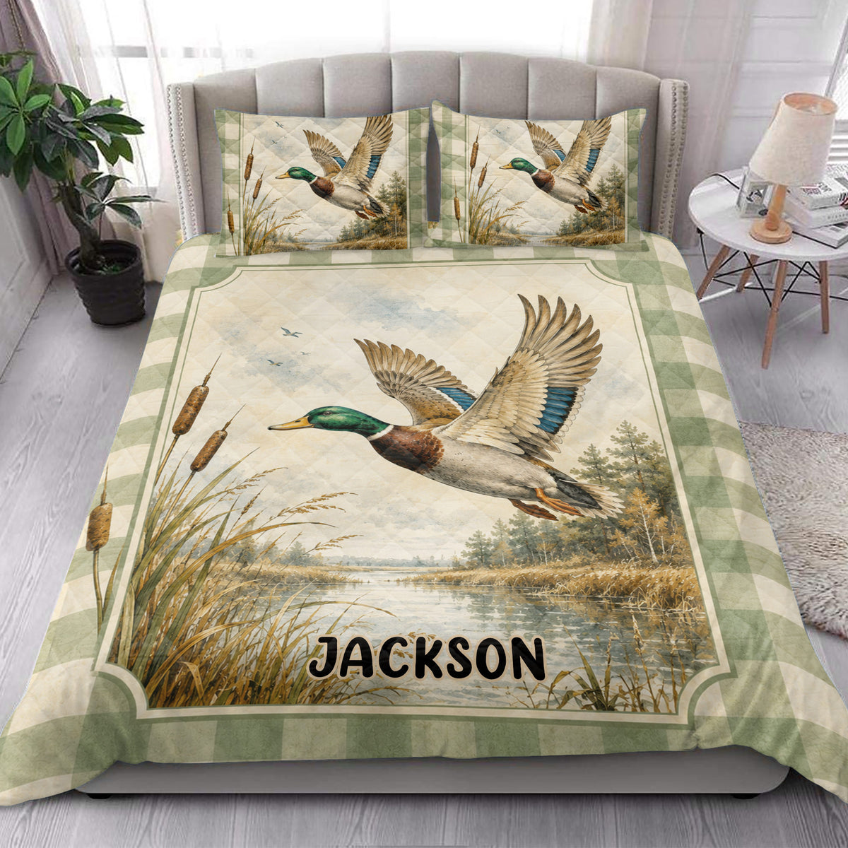 Duck hunting quilt blanket styled on a bedroom bed with flying mallard artwork and marsh landscape details