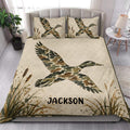 Duck hunting quilt blanket styled in a bright bedroom with camouflage duck artwork