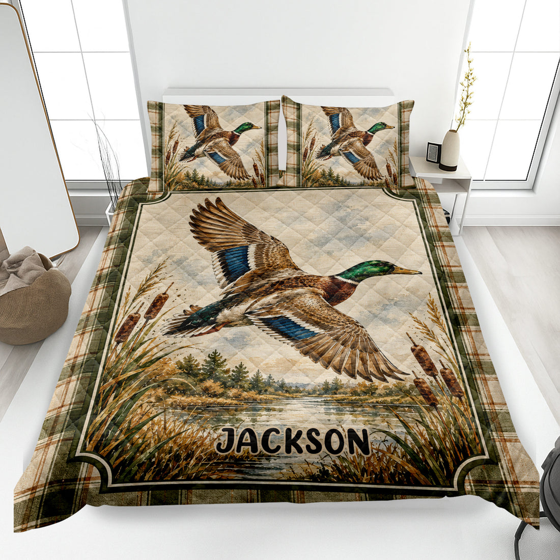 Duck hunting quilt blanket displayed on a bed with mallard artwork, marsh reeds, and rustic plaid borders