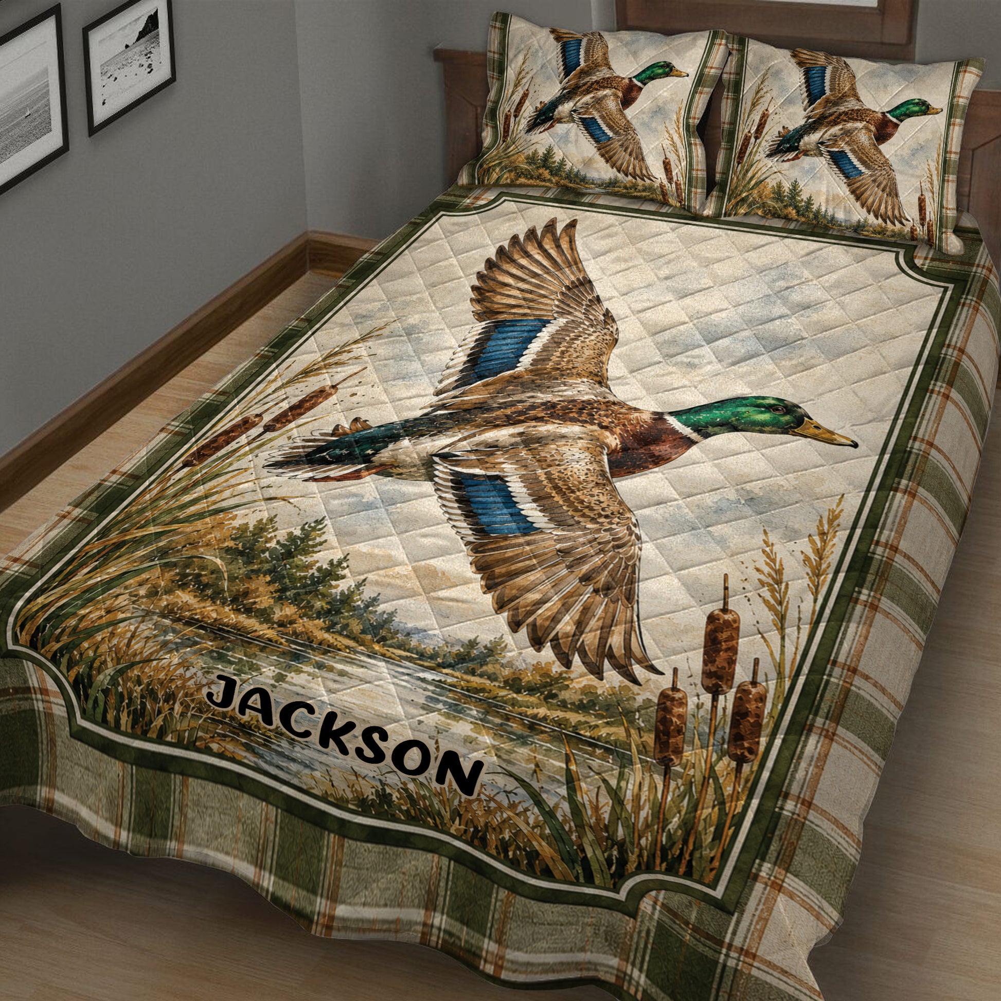 Close bedroom view of a duck hunting quilt with mallard artwork, cattails, water, and woodland scenery
