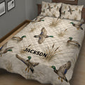 Duck hunting quilt bedding displayed in a rustic bedroom with mallards flying and resting in marsh scenery