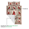 Cardinal quilt close-up showing the printed winter bird artwork and white quilted backing