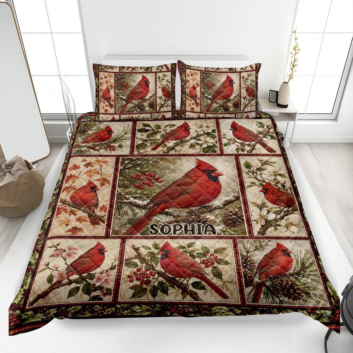 Cardinal quilt blanket displayed on a bed with red birds, berries, pinecones, flowers, and woodland artwork
