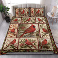 Cardinal quilt blanket styled in a bright bedroom with red birds, branches, berries, and floral panels
