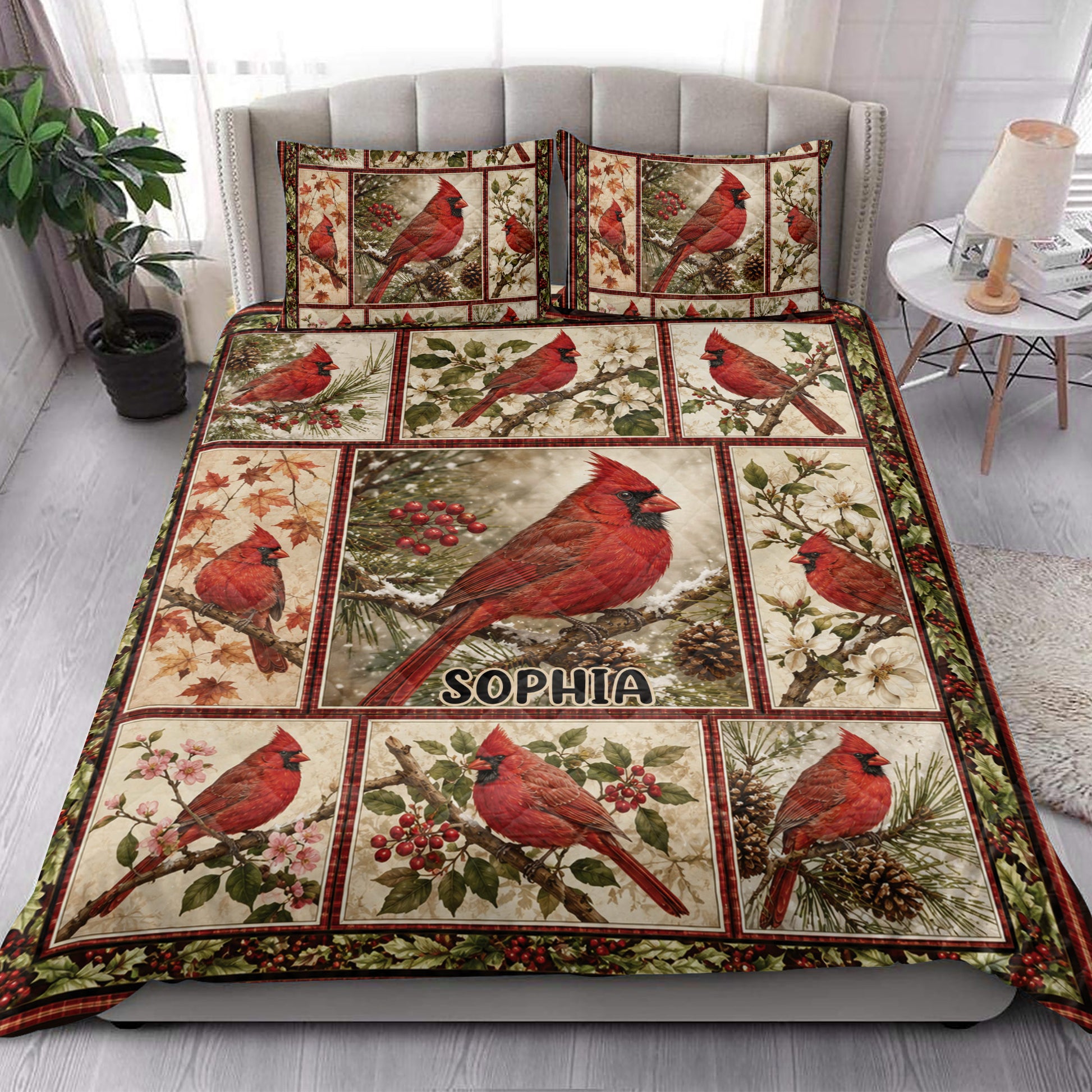 Cardinal quilt blanket styled in a bright bedroom with red birds, branches, berries, and floral panels