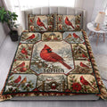 Cardinal quilt blanket styled on a bedroom bed with red birds, snowy branches, birdhouses, and winter accents