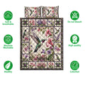 Hummingbird floral quilt blanket displayed with care and quality feature icons around the botanical bedding design