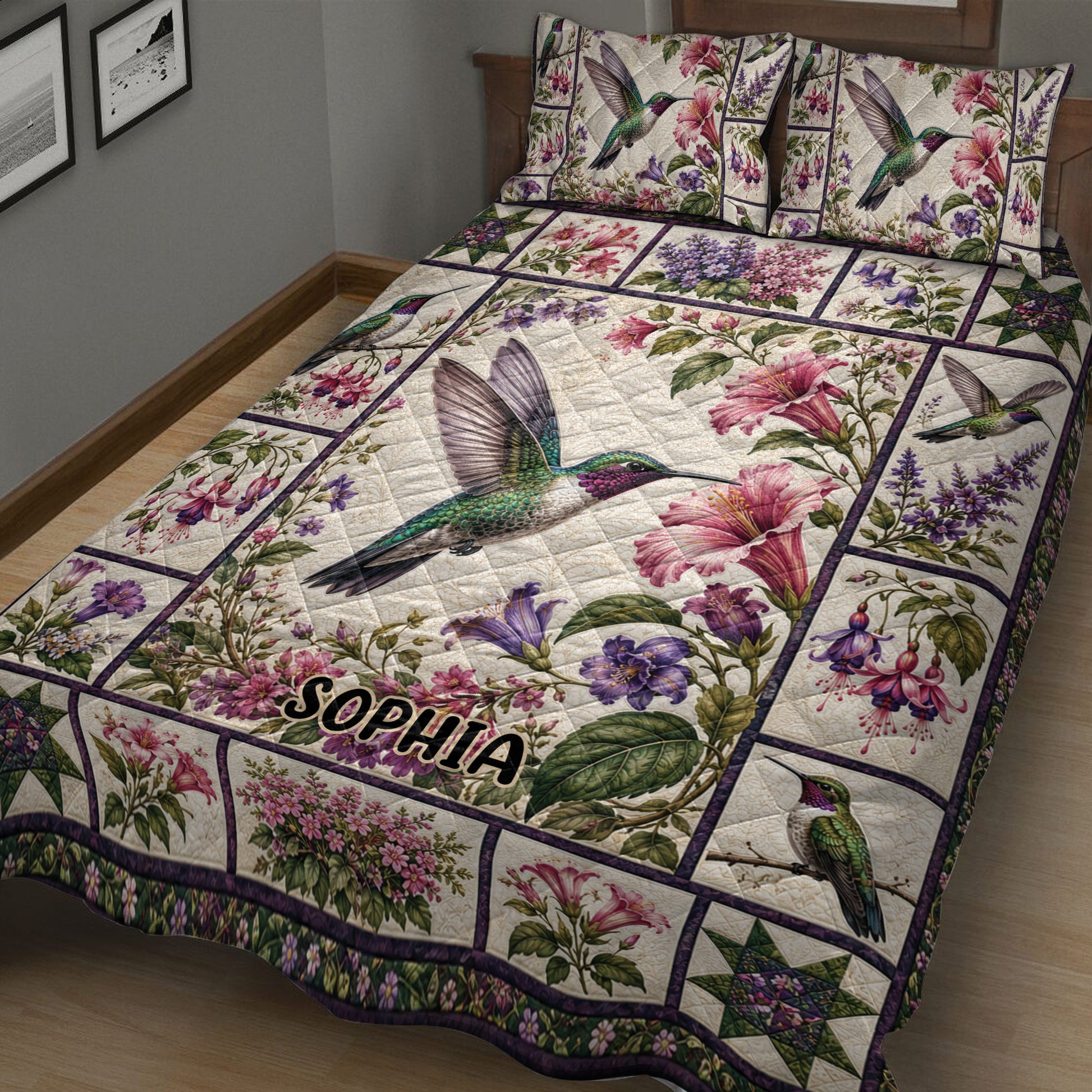 Close bedroom view of a hummingbird quilt blanket with vibrant flowers, foliage, and patchwork-style borders