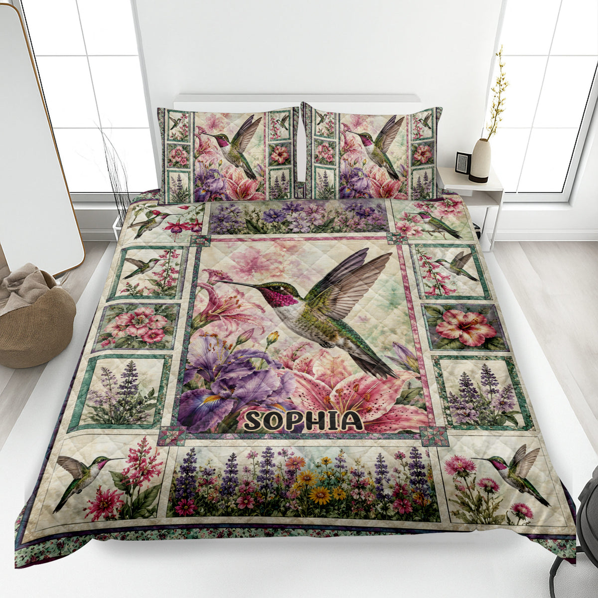 Hummingbird quilt blanket spread across a bed with colorful flowers and matching bird-themed pillows