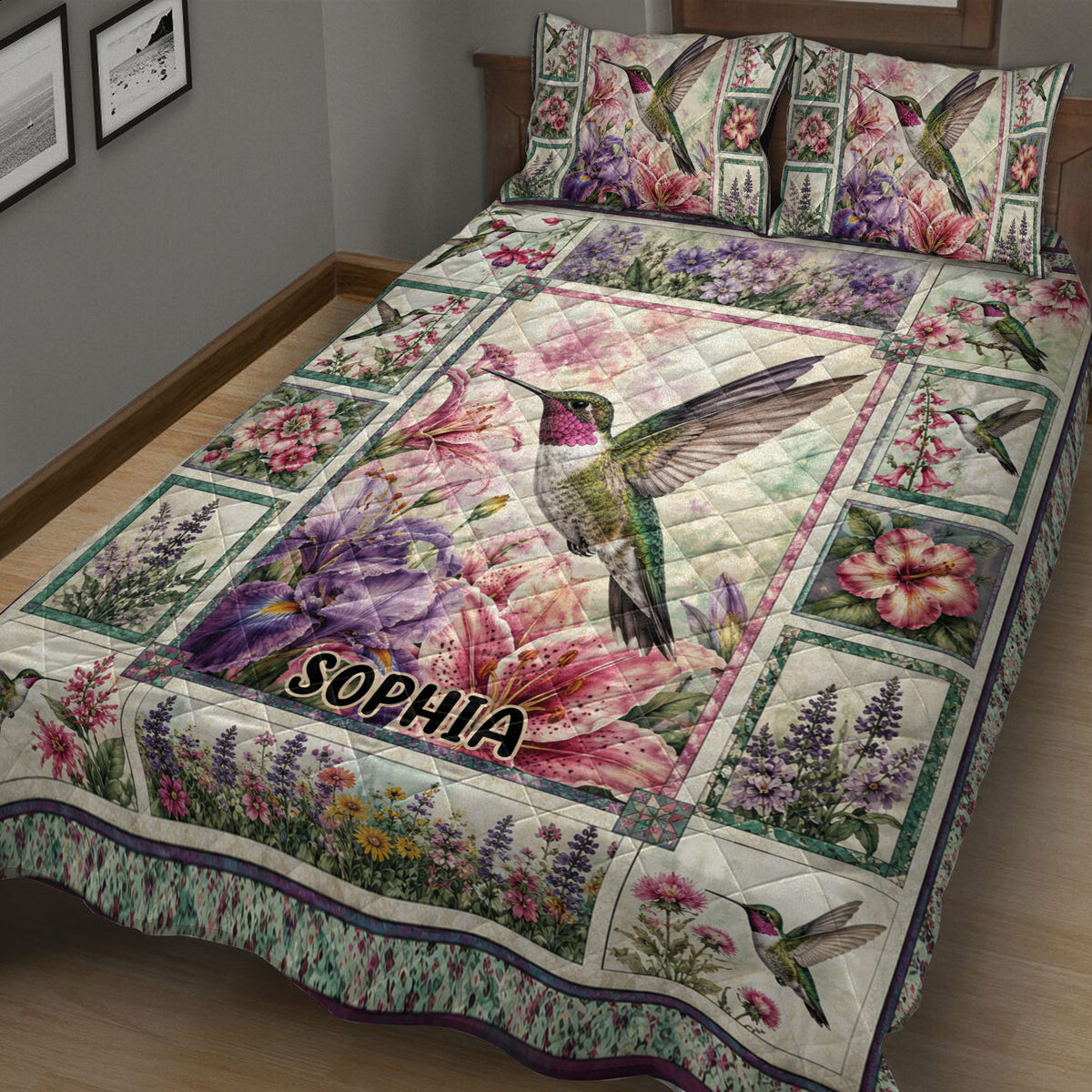 Close bedroom view of a hummingbird quilt blanket with colorful flowers and detailed botanical panels