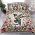 Hummingbird floral quilt blanket styled on a bright bedroom bed with matching bird artwork