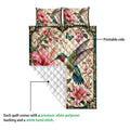 Hummingbird quilt blanket showing the printed floral side and white diamond-stitched reverse