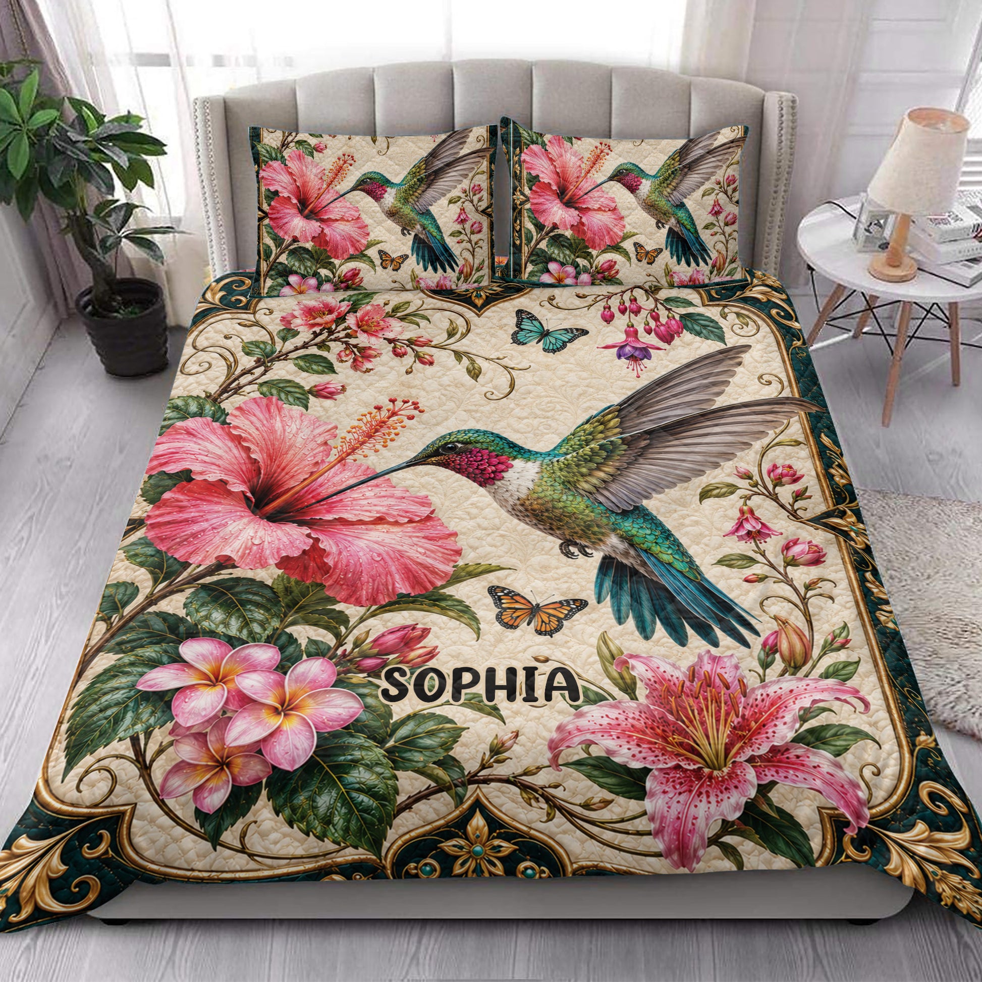 Hummingbird quilt blanket styled in a bright bedroom with tropical flowers and butterfly accents