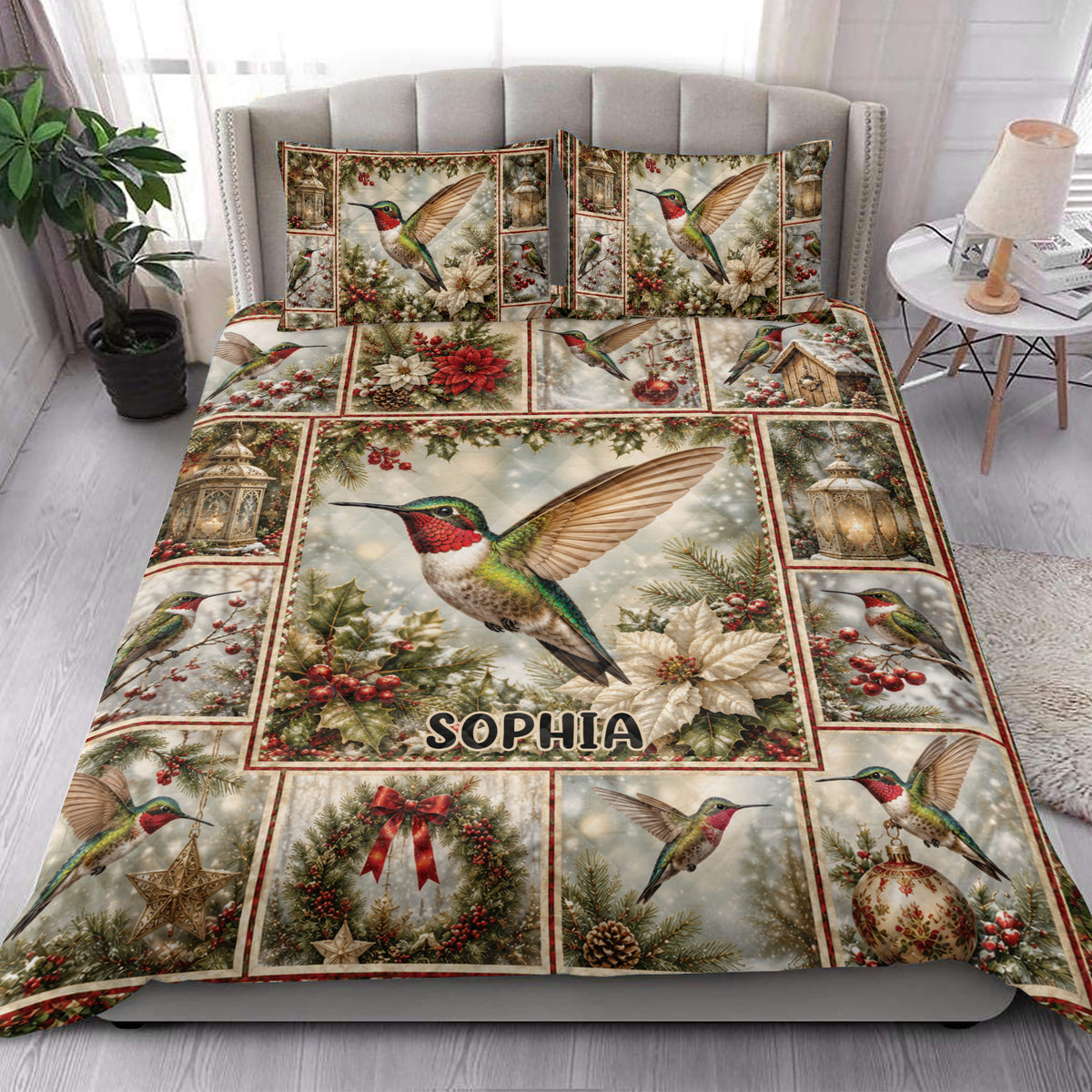 Hummingbird quilt blanket styled on a bedroom bed with poinsettias, ornaments, lanterns, and evergreen branches