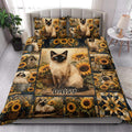 Siamese cat and sunflower quilt blanket styled across a bright bedroom bed