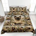Siamese cat quilt blanket spread across a bed with daisy flowers, butterflies, and coordinated cat artwork