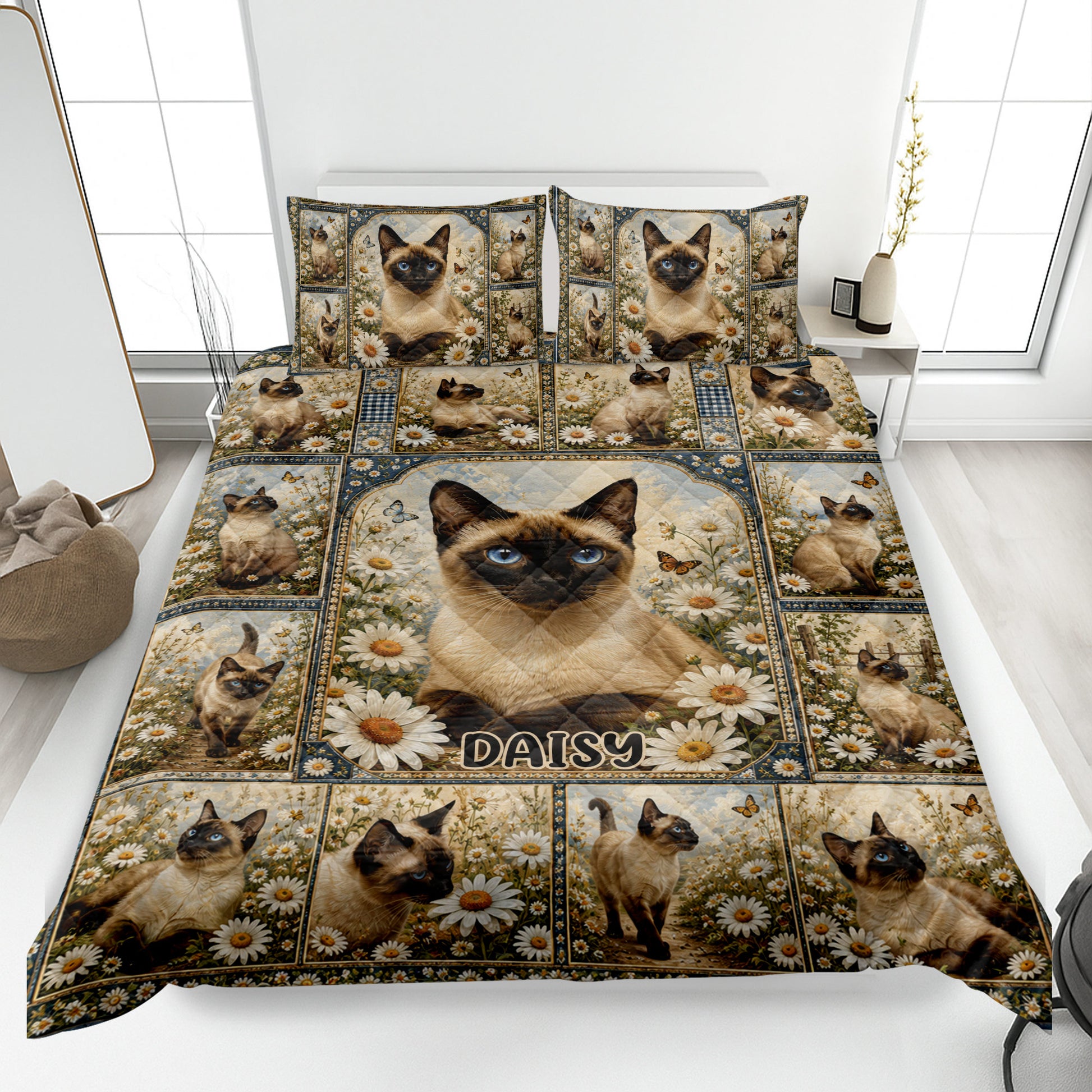 Siamese cat quilt blanket spread across a bed with daisy flowers, butterflies, and coordinated cat artwork