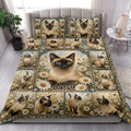 Siamese cat quilt blanket styled on a bed in a bright bedroom with floral cat artwork