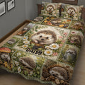 Close view of a hedgehog quilt blanket with detailed woodland artwork, flowers, leaves, and autumn foliage