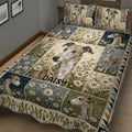 Close bedroom view of a greyhound quilt blanket featuring portrait panels, daisies, and navy blue accents