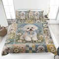 Bichon Frise quilt blanket spread across a bed with floral patchwork, blue accents, and a central dog portrait