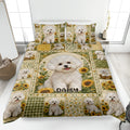 Bichon Frise quilt blanket displayed on a bed with sunflower panels and coordinated dog artwork