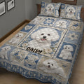 Bichon Frise quilt blanket styled on a bed with repeated white dog portraits and flowers