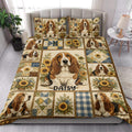 Basset hound quilt blanket styled across a bed with sunflower patchwork artwork and matching pillows