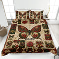 Butterfly quilt blanket displayed on a bed with red, green, and cream Christmas floral artwork