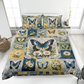 Butterfly quilt blanket displayed on a bed with blue, gold, green, and daisy patchwork artwork