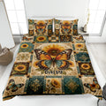 Butterfly quilt blanket displayed on a bed with sunflowers, teal accents, and vintage botanical patchwork