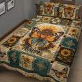 Close view of a butterfly quilt blanket with sunflowers, ornate patchwork, and warm vintage colors
