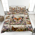 Butterfly quilt blanket spread on a bed with colorful flowers and detailed garden artwork