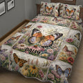 Angled bedroom view of a butterfly quilt blanket covered in flowers and garden scenes