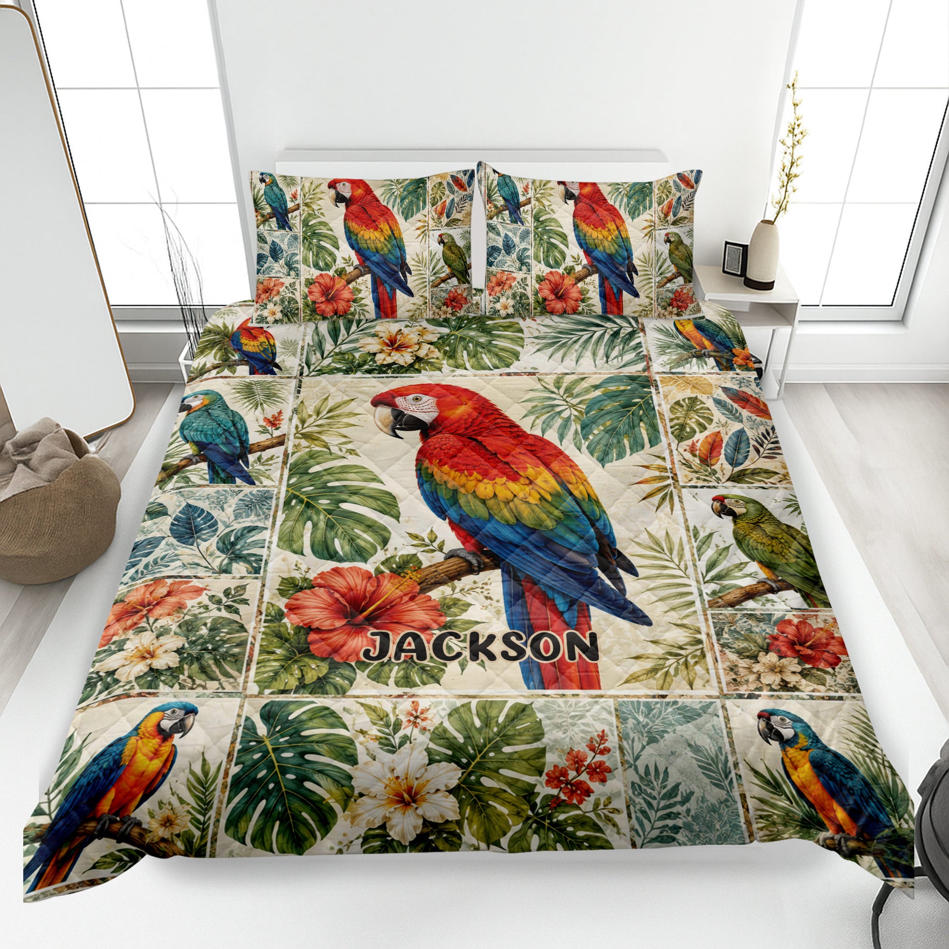 Parrot quilt blanket displayed on a bed with colorful macaws, tropical leaves, hibiscus flowers, and a custom design