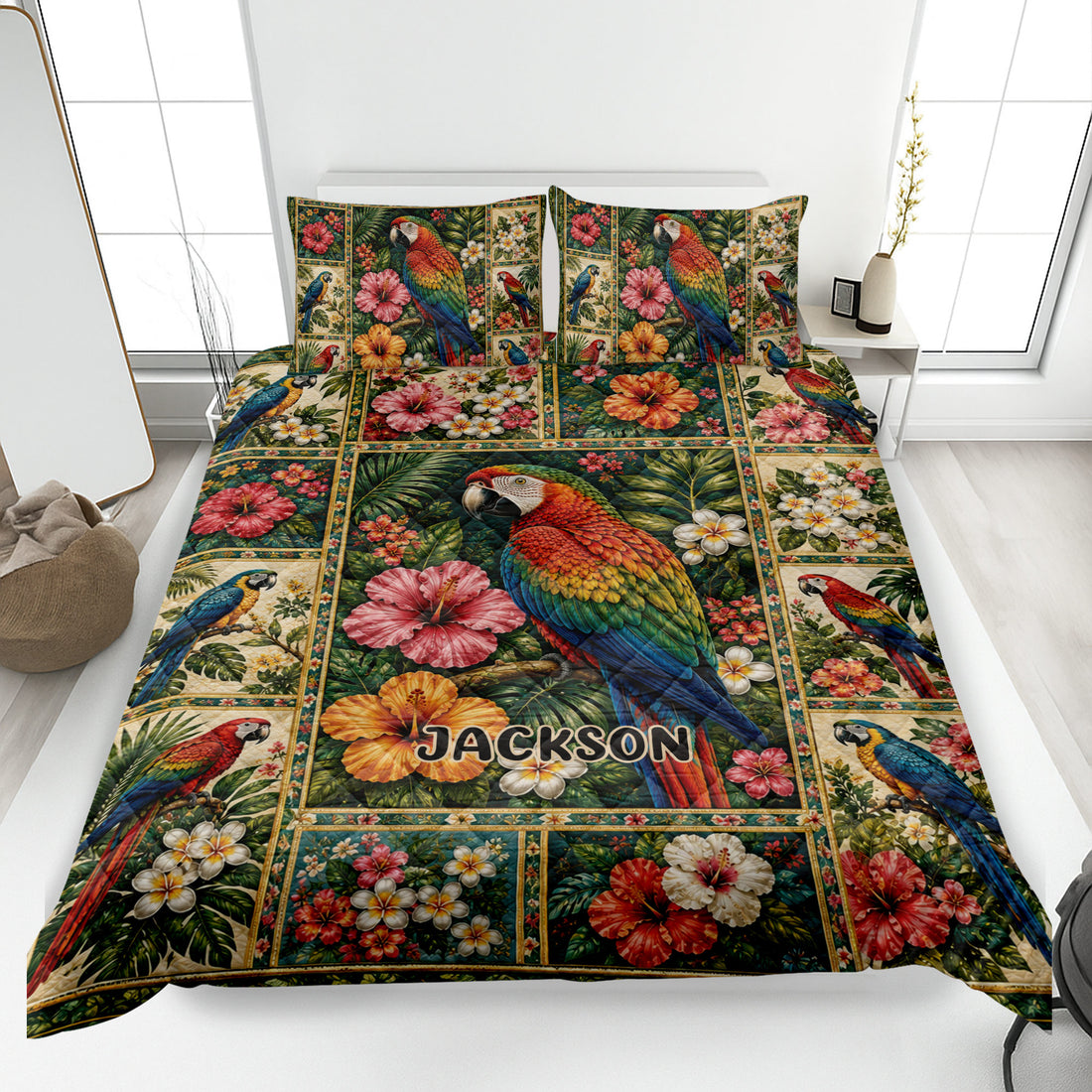 Parrot quilt blanket displayed on a bed with tropical flowers, foliage, and colorful macaw artwork