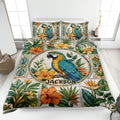 Tropical parrot quilt blanket spread across a bright bedroom with floral foliage artwork