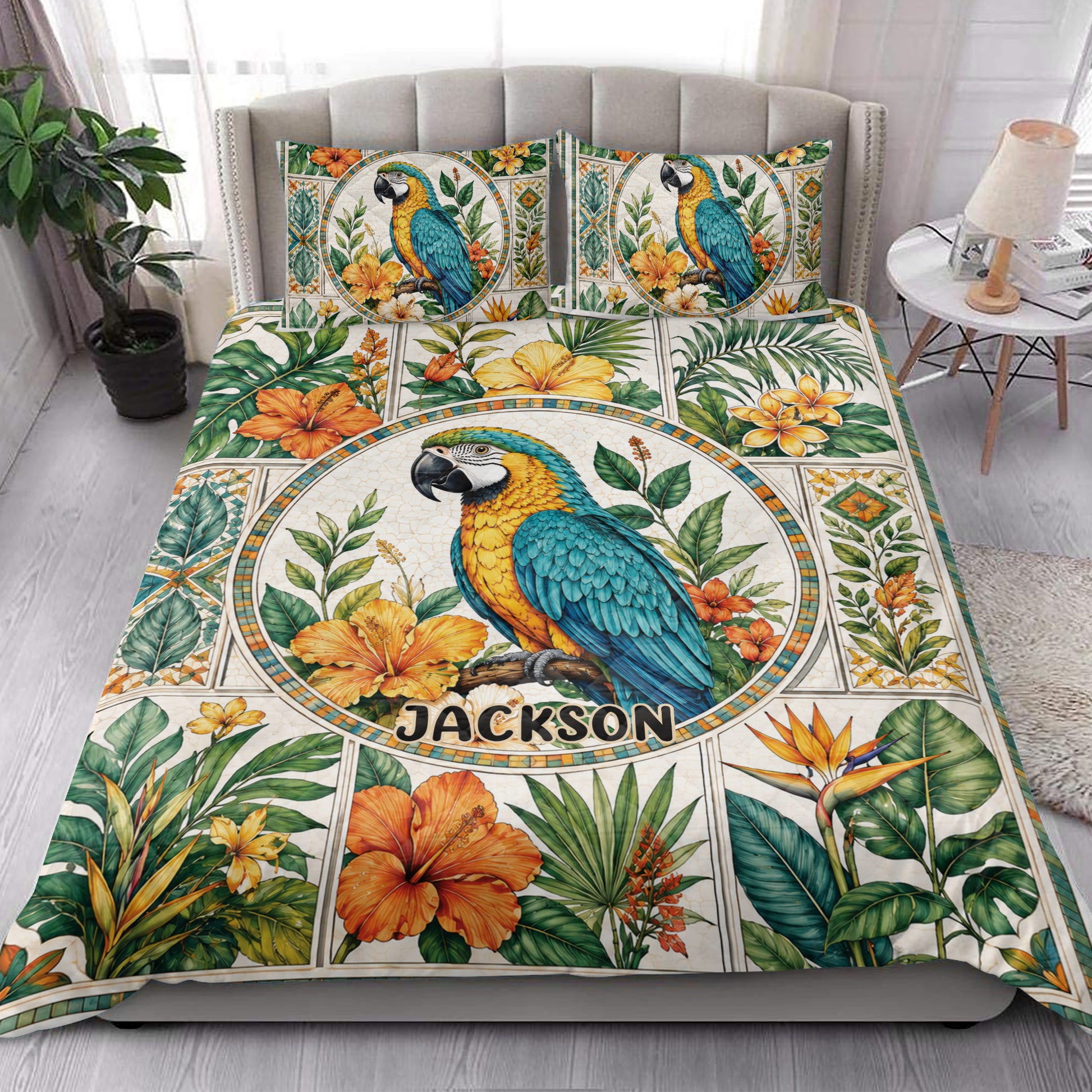 Colorful parrot quilt blanket styled on a bright bedroom bed with tropical floral artwork