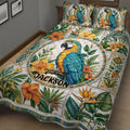 Close bedroom view of a parrot quilt blanket with lush leaves and vibrant tropical flowers