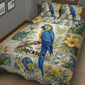 Tropical parrot quilt blanket displayed on a bed with blue macaw and vibrant botanical artwork
